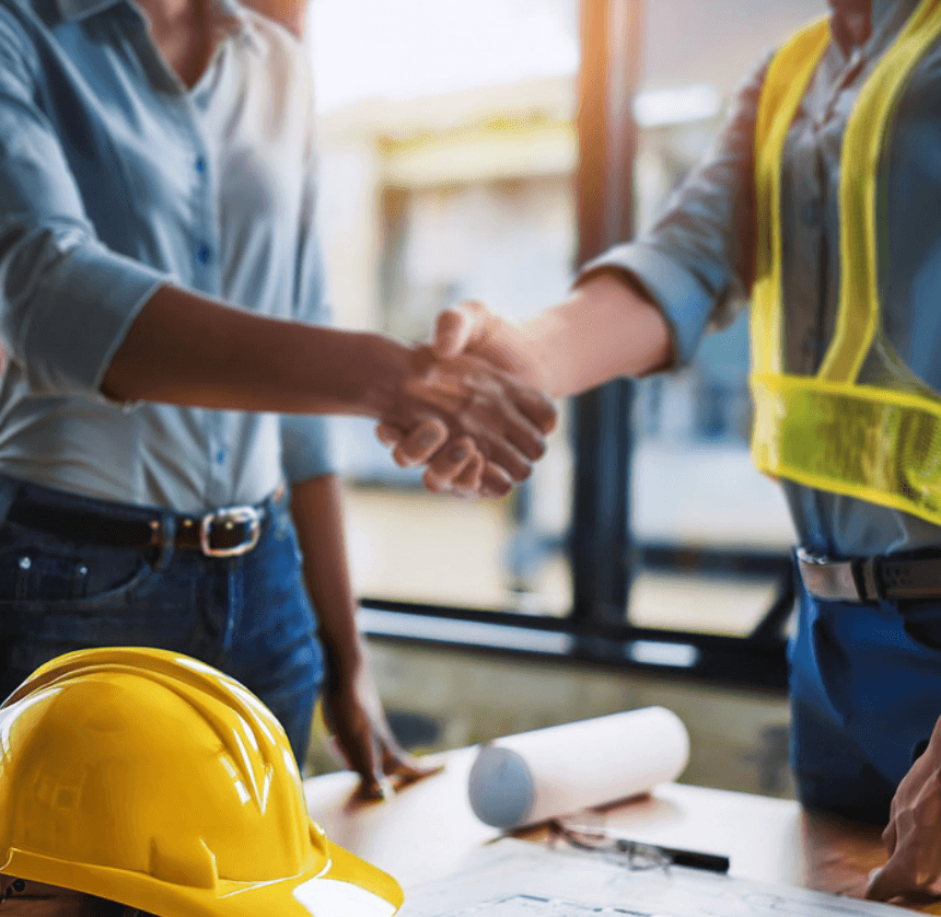 a professional contractor reviewing blueprints on a construction site, representing the comprehensive contractors insurance services offered by Insurance Company Powell, Ohio.