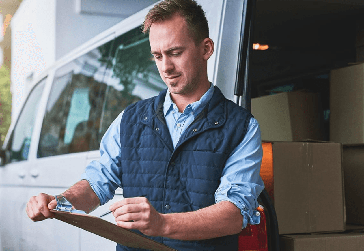 a fleet of commercial vehicles parked outside a business office, representing affordable commercial auto insurance options in Powell, Ohio, provided by Powell Insurance Company LLC.